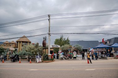 Pak Chong, Tayland, 16 Kasım 2023, Khao Yai bölgesinde turistik bir etkinlik. Ziyaretçiler dekoratif yapılar ve trafik işaretlerinin yanında yürüyüp toplanıyorlar.