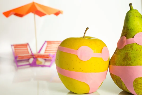 Apple and pear in a bathing suit Stock Picture