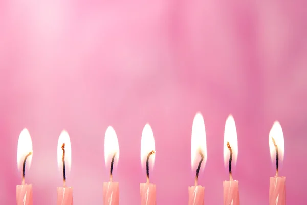 Conjunto de velas acesas rosa no fundo rosa — Fotografia de Stock
