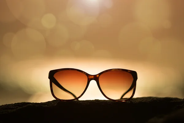 Sunglasses at Sunset and Defocused Horizon — Stock Photo, Image