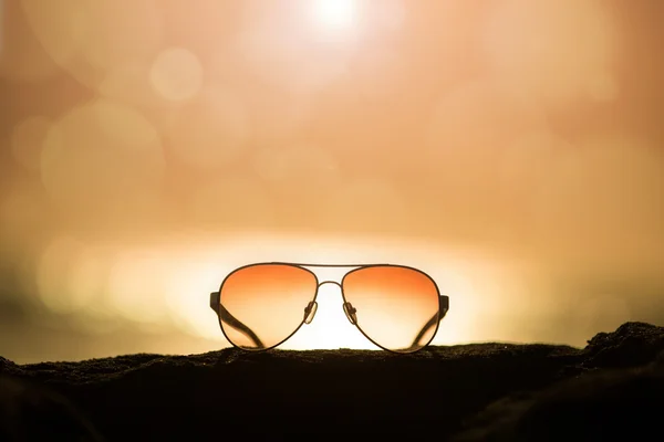 Sunglasses at Sunset and Defocused Horizon — Stock Photo, Image