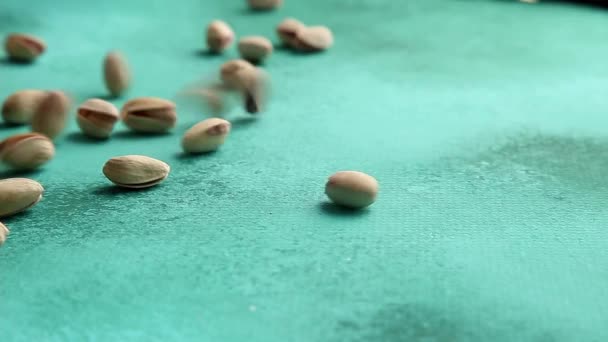 Pistachios falling on green background — Stock Video