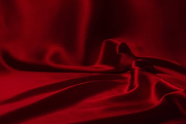 Kırmızı ipek ya da saten lüks kumaş dokusu soyut bir arka plan olarak kullanılabilir. Üst görünüm