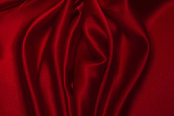 Kırmızı ipek ya da saten lüks kumaş dokusu soyut bir arka plan olarak kullanılabilir. Üst görünüm