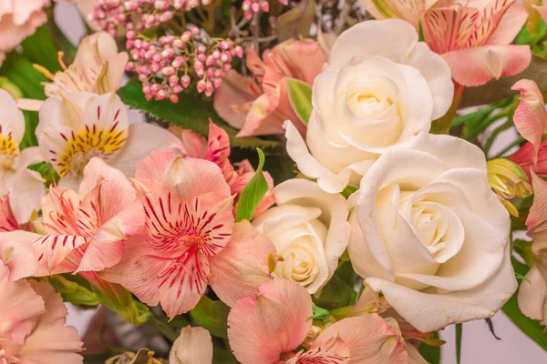 Bouquet of  soft pink flowers in pink wrapping paper.