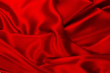 Kırmızı ve turuncu ipek ya da saten lüks kumaş dokusu soyut arkaplan olarak kullanılabilir. Üst görünüm.