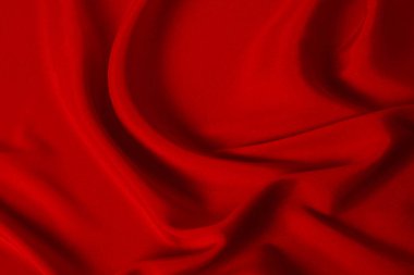 Kırmızı ipek ya da saten lüks kumaş dokusu soyut bir arka plan olarak kullanılabilir. Üst görünüm.