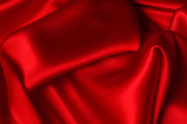 Kırmızı ipek ya da saten lüks kumaş dokusu soyut bir arka plan olarak kullanılabilir. Üst görünüm