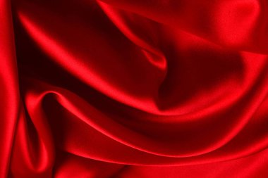 Kırmızı ipek ya da saten lüks kumaş dokusu soyut bir arka plan olarak kullanılabilir. Üst görünüm