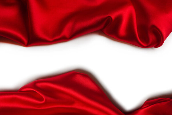 Red silk or satin luxury fabric texture can use as abstract background. Top view.