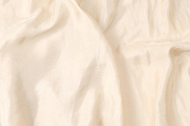 Yumuşak bej ipek kumaş arka plan. Kumaş dokusu. 