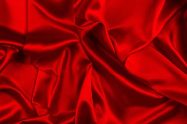 Kırmızı ipek ya da saten lüks kumaş dokusu soyut bir arka plan olarak kullanılabilir. Üst görünüm.