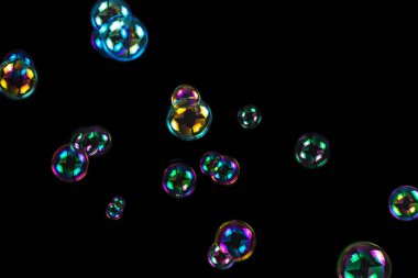 Sabun köpükleri siyah arkaplanda izole edilmiş.