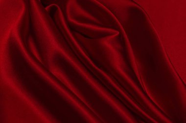 Kırmızı ipek ya da saten lüks kumaş dokusu soyut bir arka plan olarak kullanılabilir. Üst görünüm