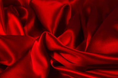 Kırmızı ipek ya da saten lüks kumaş dokusu soyut bir arka plan olarak kullanılabilir. Üst görünüm.