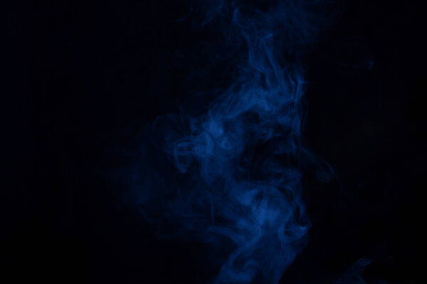 Blue and pink steam on a black background. Copy space.