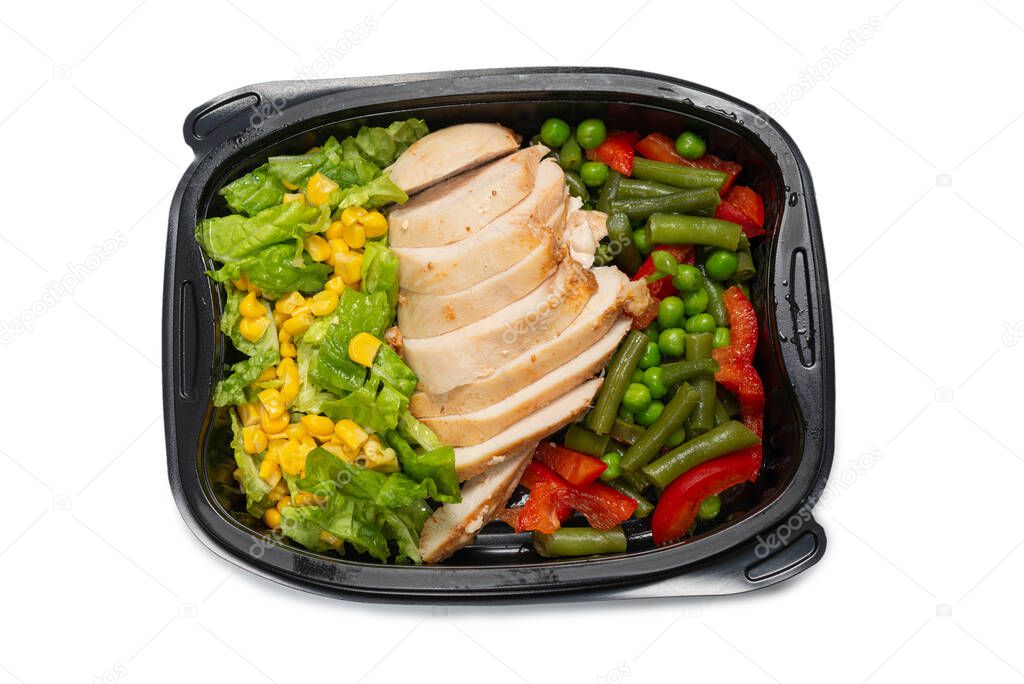 Ready food in a container. Stewed chicken, stewed vegetables. Isolated on a white background. 
