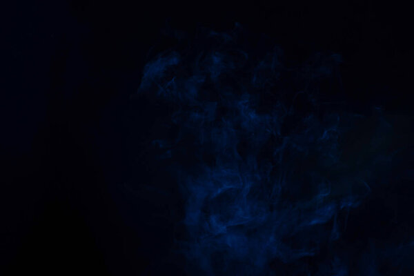 Blue and pink steam on a black background. Copy space.