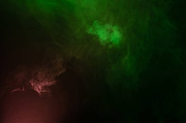 Siyah arka planda yeşil ve pembe buhar. Boşluğu kopyala.