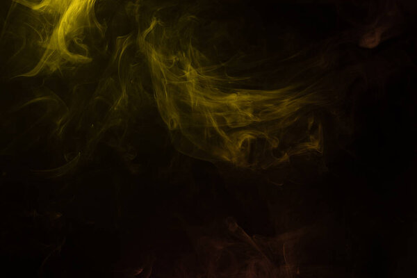 Yellow and pink steam on a black background. Copy space.