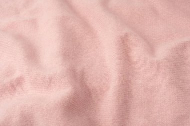 Yumuşak pembe kaşmir süveter desenli arka plan. Üst görünüm. 