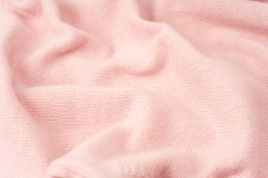 Yumuşak pembe kaşmir süveter desenli arka plan. Üst görünüm. 