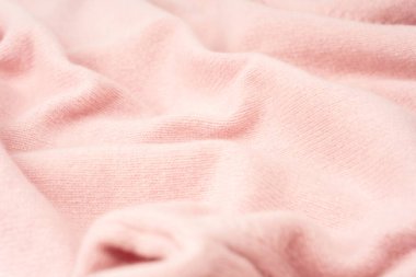 Yumuşak pembe kaşmir süveter desenli arka plan. Üst görünüm. 