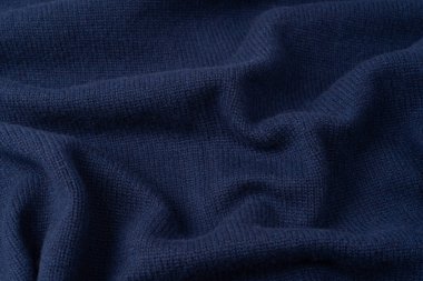 Arka plan olarak lacivert merino yün süveter dokusu. Üst görünüm. 