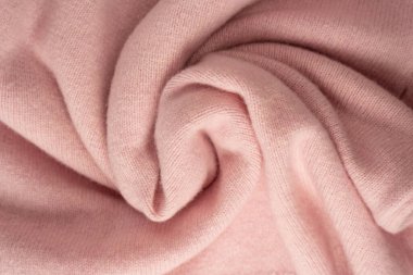 Yumuşak pembe kaşmir süveter desenli arka plan. Üst görünüm. 