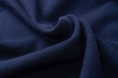 Arka plan olarak lacivert merino yün süveter dokusu. Üst görünüm. 