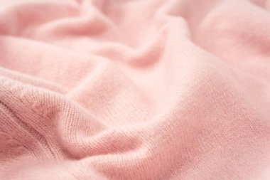 Yumuşak pembe kaşmir süveter desenli arka plan. Üst görünüm. 