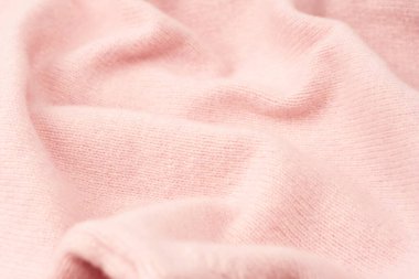 Yumuşak pembe kaşmir süveter desenli arka plan. Üst görünüm. 