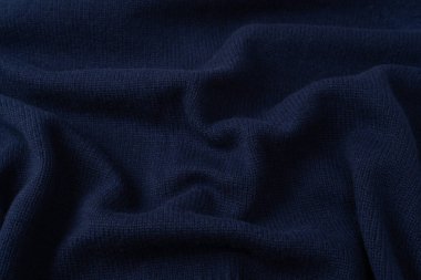 Arka plan olarak lacivert merino yün süveter dokusu. Üst görünüm. 