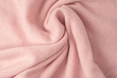 Yumuşak pembe kaşmir süveter desenli arka plan. Üst görünüm. 