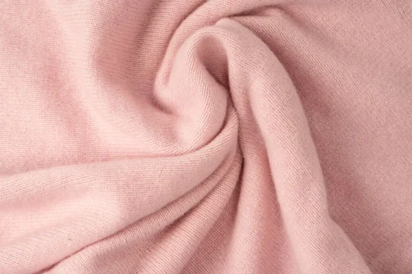 Yumuşak pembe kaşmir süveter desenli arka plan. Üst görünüm. 