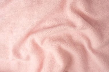 Yumuşak pembe kaşmir süveter desenli arka plan. Üst görünüm. 