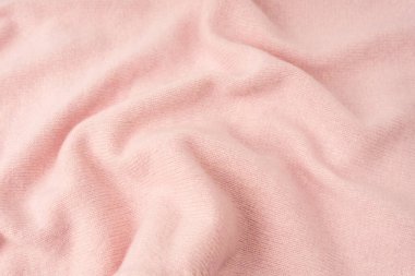 Yumuşak pembe kaşmir süveter desenli arka plan. Üst görünüm. 