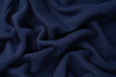 Arka plan olarak lacivert merino yün süveter dokusu. Üst görünüm. 