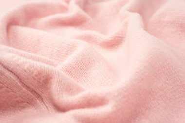 Yumuşak pembe kaşmir süveter desenli arka plan. Üst görünüm. 