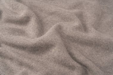 Arka plan olarak yumuşak gri merino yün süveter dokusu. Üst görünüm.