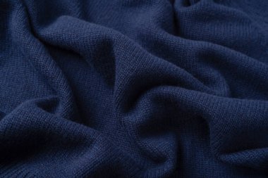 Arka plan olarak lacivert merino yün süveter dokusu. Üst görünüm. 