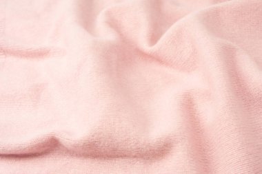 Yumuşak pembe kaşmir süveter desenli arka plan. Üst görünüm. 