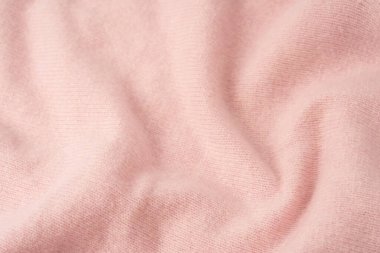Yumuşak pembe kaşmir süveter desenli arka plan. Üst görünüm. 