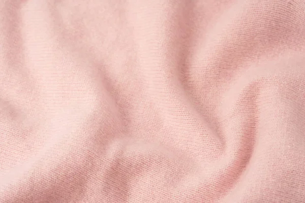 Yumuşak pembe kaşmir süveter desenli arka plan. Üst görünüm. 