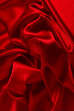 Kırmızı ipek ya da saten lüks kumaş dokusu soyut bir arka plan olarak kullanılabilir. Üst görünüm.