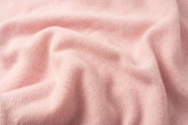 Yumuşak pembe kaşmir süveter desenli arka plan. Üst görünüm. 