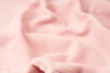 Yumuşak pembe kaşmir süveter desenli arka plan. Üst görünüm. 