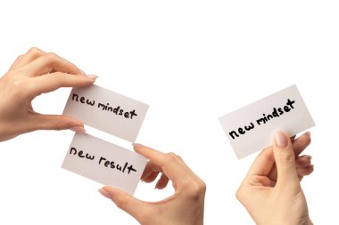 Yeni zihniyet - beyaz arka planda izole edilmiş bir kadının elindeki bir karttaki yeni sonuç metni.  