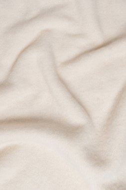 Arka plan olarak bej süveter dokusu. Üst görünüm.