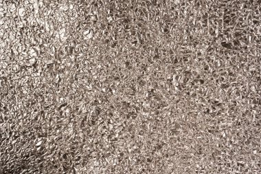 Parlak gümüş folyo arka plan. Üst görünüm.